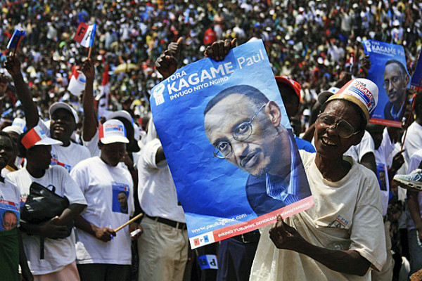 A supporter of the ruling RPF holds a poster of incumbent President Kagame at a rally ahead of next week's presidential election in Byumba