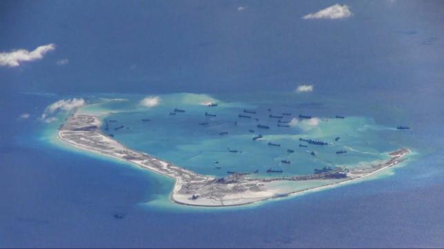 Chinese dredging vessels are purportedly seen in the waters around Mischief Reef in the disputed Spratly Islands in the South China Sea in this still image from video taken by a P-8A Poseidon surveillance aircraft provided by the United States Navy May 21, 2015. REUTERS/U.S. Navy/Handout via Reuters
