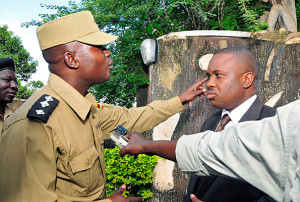 Embattled kampala lord mayor erias lukwago in a bitter word exchange with Walugembe Musa a police officer attached to yesteday's operation at his home in Wakaliga after he was denied exit from his house. PHOTO BY FAISWAL KASIRYE.