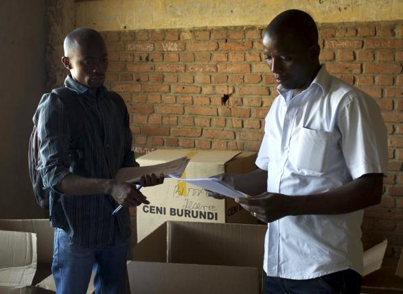 Officials of Burundi's National Electoral Commission take stock of electoral material for the upcoming parliamentary elections at a warehouse in the neighbourhood of Nyakabiga near the capital Bujumbura, June 28, 2015. REUTERS/Paulo Nunes dos Santos