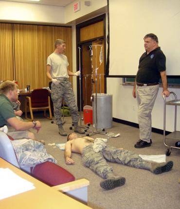 Dr. John Hagmann (R) teaches a course in treating battlefield trauma  in this handout photograph taken around 2010 and released on June 17, 2015. REUTERS/HANDOUT via Reuters