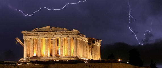 Athens, GREECE:  The ancient Greek Parthenon temple, atop the Acropolis hill overlooking Athens, is framed by a lightning bolt during a thunderstorm that broke out in the Greek capital, late 9 October 2006. Greece has experienced stormy weather since the weekend, with two regions now placed in a state of emergency because of flood-related problems that damaged homes and disrupted transport. AFP PHOTO ARIS MESSINIS  (Photo credit should read ARIS MESSINIS/AFP/Getty Images)