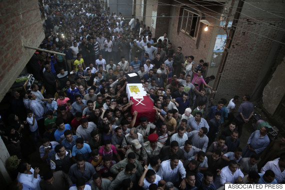 Egyptians carry the coffin of 1st Lt. Mohammed Adel Abdel Azeem, killed in Wednesday's attack by Islamic militants in the Sinai, during the funeral procession at his home village Tant Al Jazeera in Qalubiyah, north of Cairo, Egypt, Thursday, July 2, 2015. Islamic State-linked militants launched an unprecedented wave of attacks in northern Sinai on Wednesday, setting off the fiercest fighting the peninsula has seen in decades and undermining government efforts to stem the insurgency. (AP Photo/Hassan Ammar)