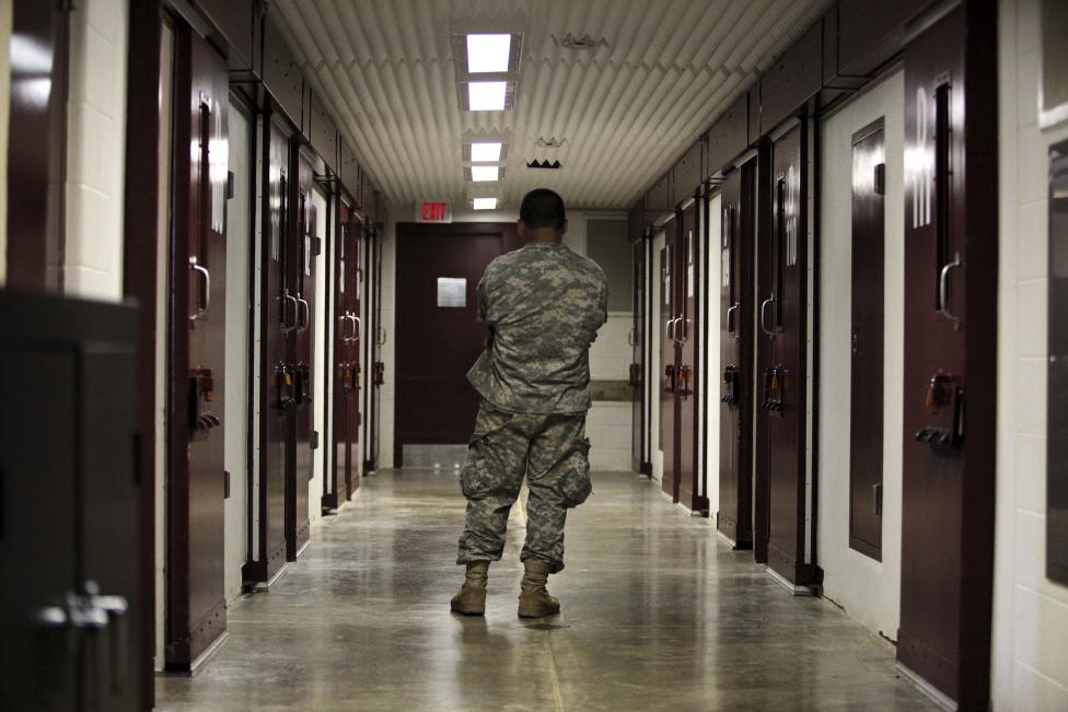 A U.S. military guard stands in a cell block at the Camp 5 detention facility at Guantanamo Bay U.S. Naval Base, Cuba in this May 31, 2009 file photo reviewed by the U.S. military. REUTERS/Brennan Linsley/Pool/Files
