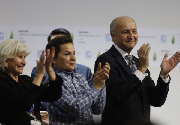 (L-R) French Ambassador for the international Climate Negotiations Responsible for COP21 Laurence Tubiana, Executive Secretary of the United Nations Framework Convention on Climate Change (UNFCCC) Christiana Figueres and Foreign Affairs Minister and President-designate of COP21 Laurent Fabius clap after adoption of a historic global warming pact at the COP21 Climate Conference in Le Bourget, north of Paris, on December 12, 2015. Envoys from 195 nations on December 12 adopted to cheers and tears a historic accord to stop global warming, which threatens humanity with rising seas and worsening droughts, floods and storms. AFP PHOTO / FRANCOIS GUILLOT / AFP / FRANCOIS GUILLOT (Photo credit should read FRANCOIS GUILLOT/AFP/Getty Images)