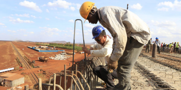 A Chinese engineer and a local construction worker work on a section of the Mombasa-Nairobi standard gauge railway (SGR) in Emali, Kenya October 10, 2015. The China Road and Bridge Corporation (CRBC) tasked with the construction work at a cost of 3.8 billion U.S. dollars is due for completion in mid-2017. REUTERS/Noor Khamis