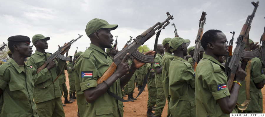 South Sudanese rebel soldiers raise their weapons at a military camp in the capital Juba, South Sudan, Thursday, April 7, 2016. South Sudan's rebels have set up camp at two designated sites in the capital as part of the process to secure the city for their leader Riek Machar's return later this month, and eventually reintegrate into the split army, after over two years of war. (AP Photo/Jason Patinkin)