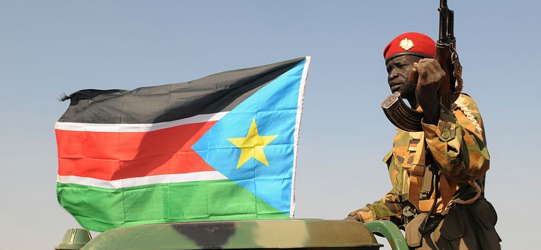 South Sudanese People's Liberation Army (SPLA) national army soldiers patrol the streets with a pick-up truck after capturing the town of Bentiu, on January 12, 2014. Mediators pushed hard for a ceasefire in South Sudan as fighting raged today for the last rebel-held town and the full extent of the destruction wrought began to emerge. With up to 10,000 dead and nearly half a million displaced, the full scale of the destruction inflicted on the world's youngest nation is just starting to become clear. AFP PHOTO / SIMON MAINA (Photo credit should read SIMON MAINA/AFP/Getty Images)