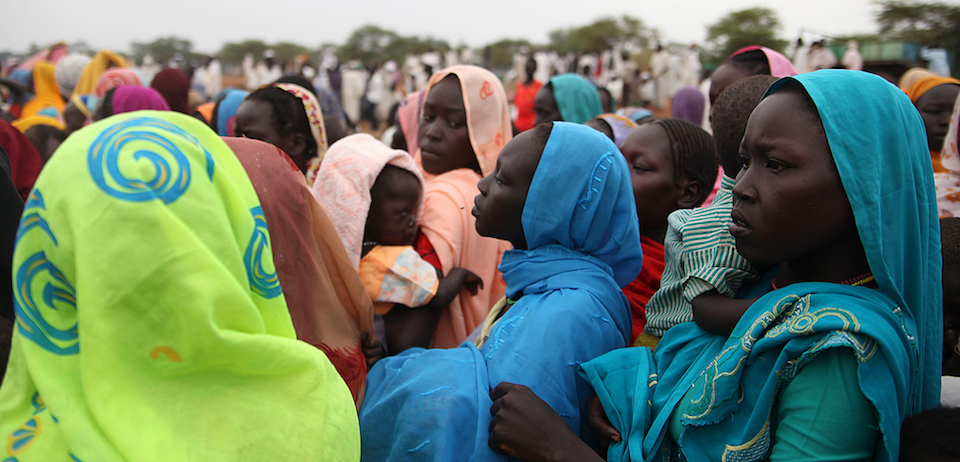 This photo taken on June 15, 2012, at the Jamam refugee camp, shows mothers queueing at a Medecin Sans Frontiere (MSF) field hospital in South Sudan's Upper Nile state, where over 100,000 refugees have fled conflict in Sudan's Blue Nile state since September. MSF says malnutrition in refugee camps is way above emergency levels and especially amongst under five year-olds, that suffer dehydration and diarrhoea from a lack of clean water. AFP PHOTO/Hannah McNEISH (Photo credit should read HANNAH MCNEISH/AFP/GettyImages)