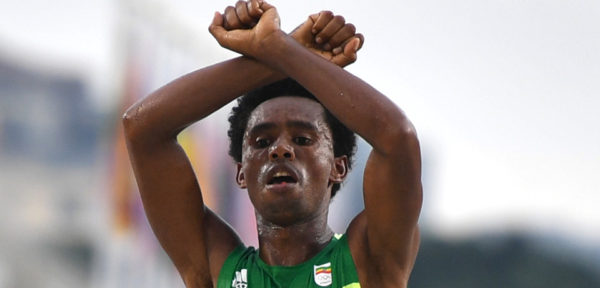 Ethiopia's Feyisa Lilesa crossed his arms above his head at the finish line of the Men's Marathon athletics event of the Rio 2016 Olympic Games at the Sambodromo in Rio de Janeiro on August 21, 2016. Lilesa crossed his arms above his head as he finished the race as a protest against the Ethiopian government's crackdown on political dissent. / AFP / OLIVIER MORIN (Photo credit should read OLIVIER MORIN/AFP/Getty Images)