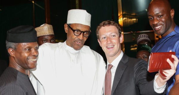 Nigerian President Muhammadu Buhari (C) and Vice President Yemi Osinbajo (L) pose as Facebook founder Mark Zuckerberg (2nd R) makes a selfie picture with them, during a visit to the presidential palace in Abuja, on September 2, 2016.  Nigerian President Muhammadu Buhari on September 2 praised Facebook founder Mark Zuckerberg for inspiring young entrepreneurs during his surprise visit to the west African country this week, his office said. Zuckerberg who arrived in Nigeria on Tuesday and has met with young entrepreneurs at information technology and computer centres in the country's commercial hub of Lagos and the capital Abuja.  / AFP / SUNDAY AGHAEZE        (Photo credit should read SUNDAY AGHAEZE/AFP/Getty Images)