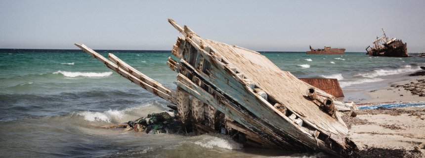 The remains of a refugee boat seen on the beach in Zuwara, Libya, Aug. 17, 2016. According to locals, the boat was washed ashore alongside many bodies of drowned refugees and migrants. Zuwara used to be the main departure point for refugees and migrants getting smuggled to Europe over the Mediterranean. The business was banned by the local council after several hundreds of bodies were washed ashore in 2015. The ban is enforced by a militia known as the Black Masks. Human smuggling moved to nearby Sabratah and Zuwara turned to oil and diesel smuggling.